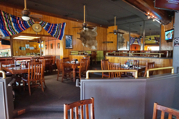 Interior of La Mojarra Loca, a Mexican restaurant, with colorful decorations and booths.
